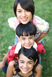 Image of two girls and a boy smiling