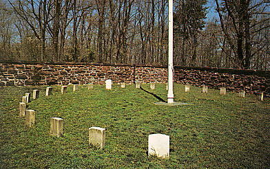 A picture of upright headstones placed in a circle around the Balls Bluff flag pole.