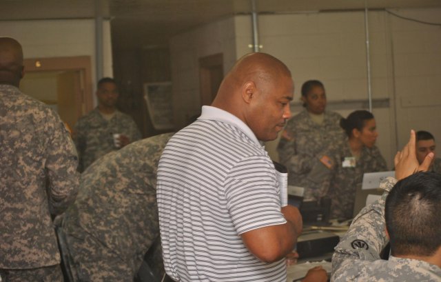 Gary Rucks, a marine cargo specialist, plays the role of harbor master and mentor during a vessel discharge exercise at Camp Shelby, Miss., designed to evaluate the readiness of the 1398th Deployment and Distribution Support Battalion before the unit's deployment to the U.S. Central Command area of operations. (Photo by 1st Lt. Furaha Mujacera, 1398th Deployment and Distribution Support Battalion.)