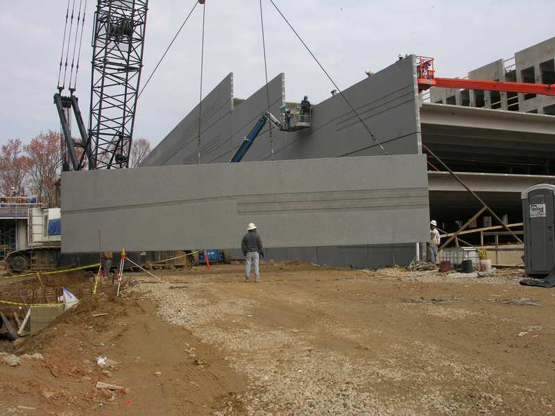 Precast panel being raised to become part of the parking garage wall 