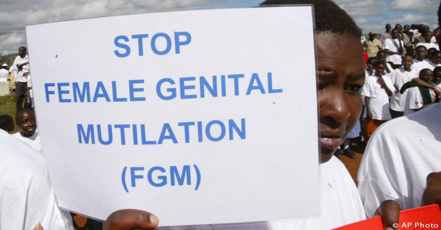 A Masai girl holds a protest sign during the anti-Female Genital Mutilation (FGM) run in Kilgoris, Kenya, April 21, 2007. [AP File Photo]