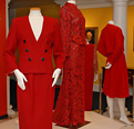 4 mannequins wearing First Ladies' red dresses and red suits on display.