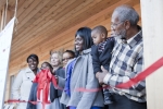 One of the new homeowners, Layika Culley, and her family cut the ribbon to her new ultra-efficient home in the historic Deanwood neighborhood. For more photos of the Empowerhouse ribbon cutting, <a href="/node/580963">view our photo gallery</a>. | Photo courtesy of Sarah Gerrity, Energy Department.