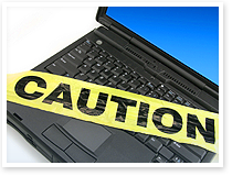 An image of a laptop computer with "Caution" tape on the keyboard