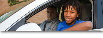 Teen and driving instructor in a car