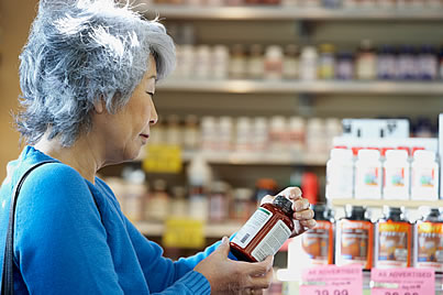 mujer con botella de suplementos