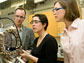 Photo of Charles Sykes and two graduate students using a scanning tunneling microscope.