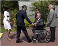 From left, First Lady Michelle Obama and President Barack Obama are greeted by ABMC Secretary Max Cleland, Normandy American Cemetery Superintendent Dan Neese and ABMC employee John Marshall.