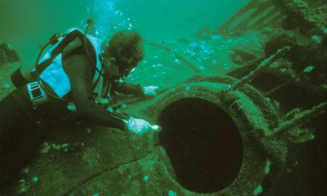 A diver examines the wreck of U-85.