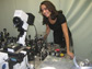 Photo of Markita Landry standing with a Total Internal Reflection Fluorescence Microscope.