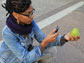 Photo of a young woman taking a photo for a paper prototype used to demonstrate the Forage City app.