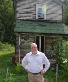 Chief White with house slated for demolition under Flood Plain Easement Project