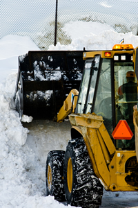 Heavy equipment shoveling heavy snow