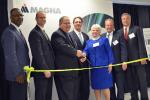 Vehicle Technologies Program Manager Patrick B. Davis gets ready to cut the ribbon at Magna E-Car's new electric drive component plant in Michigan. From left: Mike Finney - CEO, Michigan Economic Development Corporation; Gary Meyers - VP/General Manager, Magna E-Car USA, LP; Pat Davis; Kevin Pavlov - Chief Operating Officer, Magna E-Car Systems; Marilyn Hoffman, Township Supervisor, Grand Blanc Township, Michigan; Joseph Graves, State Representative 51st District, Michigan House of Representatives; Tim Herman, CEO, The Genesee County Chamber of Commerce. | Photo courtesy of Magna E-Car. 