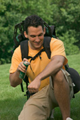 Hiker applying bug spray