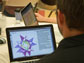 Photo of teacher John Sheridan viewing Geometer's Sketchpad on a laptop.