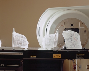 Lattice face masks sitting on patient bed prior to radiation therapy