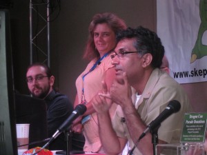 Man and woman looking at Dr. Khan speaking into a microphone
