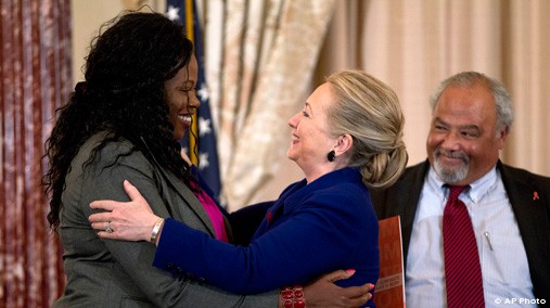 Secretary of State Hillary Rodham Clinton greets Florence Ngobeni-Allen, ambassador for the Elizabeth Glaser Pediatric AIDS Foundation, Nov. 29, 2012, during a ceremony in recognition of World AIDS Day, where she released the U.S. President's Emergency Plan for AIDS Relief Blueprint for Creating an AIDS- Free Generation. At right U.S. Global AIDS Coordinator Eric P. Goosby. [AP Photo]