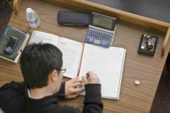 Boy writing in notebook