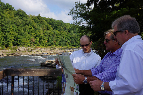  USDA Rural Development Deputy Under Secretary Doug O’Brien (left) and Rural Development State Director Thomas Williams (right) review the Great Allegheny Passage trail map with David Kahley (center) of The Progress Fund. USDA photo by Dawn Bonsell