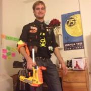 A young man holding a NERF gun.