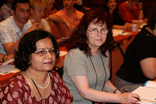 Raka Jain, India, and Eva Keller, Hungary, sitting and listening to presentations during the plenary session.