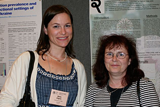 Maria Ellgren, AstraZeneca, Sweden and Eva Keller, Hungary standing together and smiling in front of poster presentations.