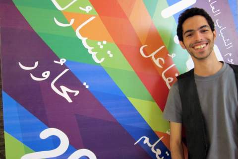 Al Zaghal stands beside his winning poster