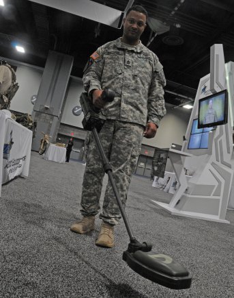 Sgt. 1st Class Mario Whitaker shows a Rapid Equipping Force-procured Mine Hound, operated by Soldiers in Afghanistan for improvised explosive device detection. The venue is the Washington Auto Show in February 2013, in the nation's capital.