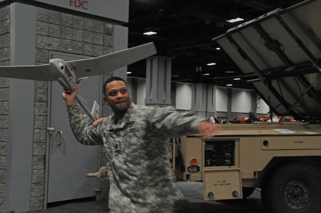 Sgt. 1st Class Mario Whitaker demonstrates how a Soldier would run and launch a Rapid Equipping Force-procured Raven unmanned aircraft. Raven is used by Soldiers in Afghanistan for surveillance. The venue is the Washington Auto Show in February 2013, in the nation's capital.