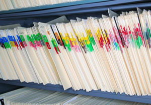 Photo of folders in a vertical file cabinet.