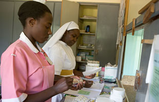 Nurses prepare medication for distribution to patients at the pharmacy in the Ibanda hospital, Uganda