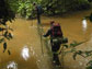 Students cross a storm-swollen river in Gabon.