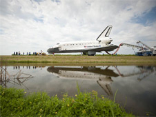 Space shuttle Atlantis is towed to the Orbiter Processing Facility (OPF).