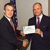 U.S. Customs Commissioner Raymond W. Kelly presenting the first National Permit for Customs broker to Jacob Holtzscheiter, Vice President of Customs for A.N. Deringer Corporation.