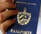 A woman holds up a Cuban passport in a regional immigration office in Havana (Cuba).