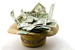 Photograph of a hat full of dollar bills.