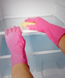 Person cleaning the inside of a refrigerator
