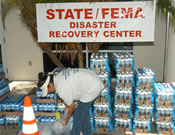 A volunteer organzing cases of bottled water