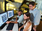 Photo of grad students and assistant professor working on nanometer-scale patterns on a computer