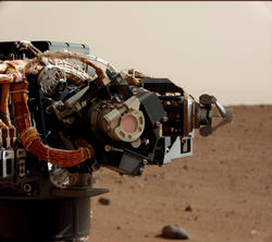 Mastcam image of the Mars Hand Lens Imager (MAHLI) on Curiosity's arm, during the 30th Martian day, or sol, of the rover's mission on Mars (Sept. 5, 2012).