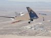 The upgraded X-48C version of Boeing's Blending Wing Body subscale research aircraft banks over Rogers Dry Lake near 