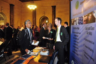 Attendees at the Sustainability Summit exchange explore the displays in the Commerce Department's lobby