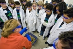 An LBNL scientist explains the properties of liquid nitrogen to students on Bring Your Sons and Daughters to Work Day. | Courtesy of Lawrence Berkeley National Lab | Credit: Roy Kaltschmidt.
