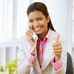 Photograph of a young woman dressed for the office, giving the thumbs up.