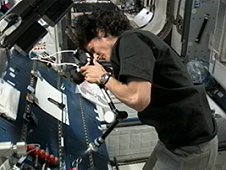 NASA astronaut Suni Williams photographing InSPACE-3 vial assembly after particles redistribution operation on the International Space Station. (NASA)