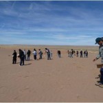 This image shows USGS scientists working with students and members of tribal nations to plant seeds on the sand dunes in the southwest as a means to help facilitate plant growth and dune stabilization. The USGS is studying conditions in this area and helping decisionmakers identify strategies to maintain sand dune stability and enhance the area's ecology. You can find out more about the USGS project at http://geomaps.wr.usgs.gov/navajo.