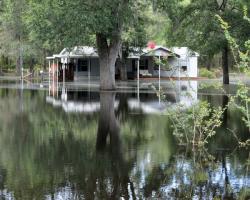 A home surrounded and submerged in flood waters