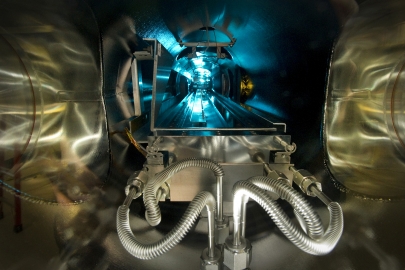 At Brookhaven National Laboratory, scientists have developed a custom-built machine that can grow special lenses, one atomic layer at a time. The machine is as long as an entire room, and scientists use a reprogrammed Xbox controller to direct a transport car through the vacuum-sealed chamber (pictured). The transport car collects plasma-borne particles that form the lenses that will eventually be used to focus high-intensity x-ray beams to reveal the details of nano material structures. <a href="http://www.bnl.gov/ps/news/news.php?a=23511" target="_blank">Learn more about the deposition chamber</a>. | Photo courtesy of Brookhaven National Laboratory.